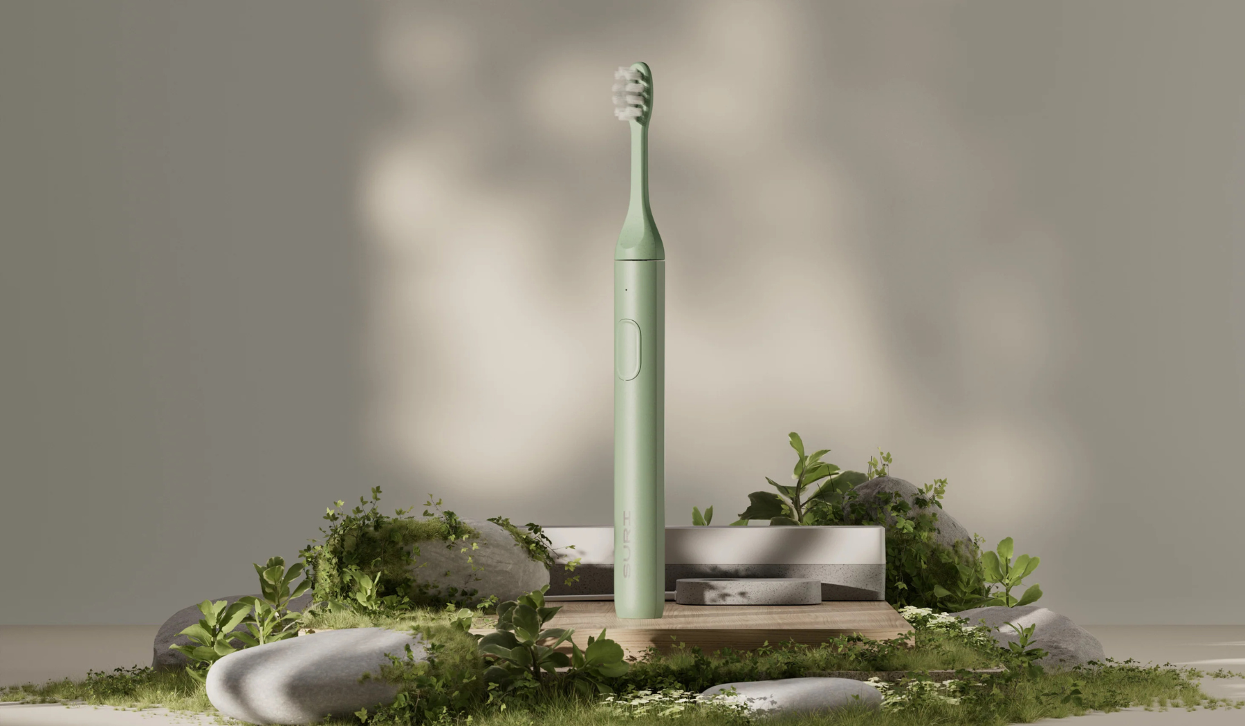 Green Suri electric toothbrush and charger displayed on rocks and moss