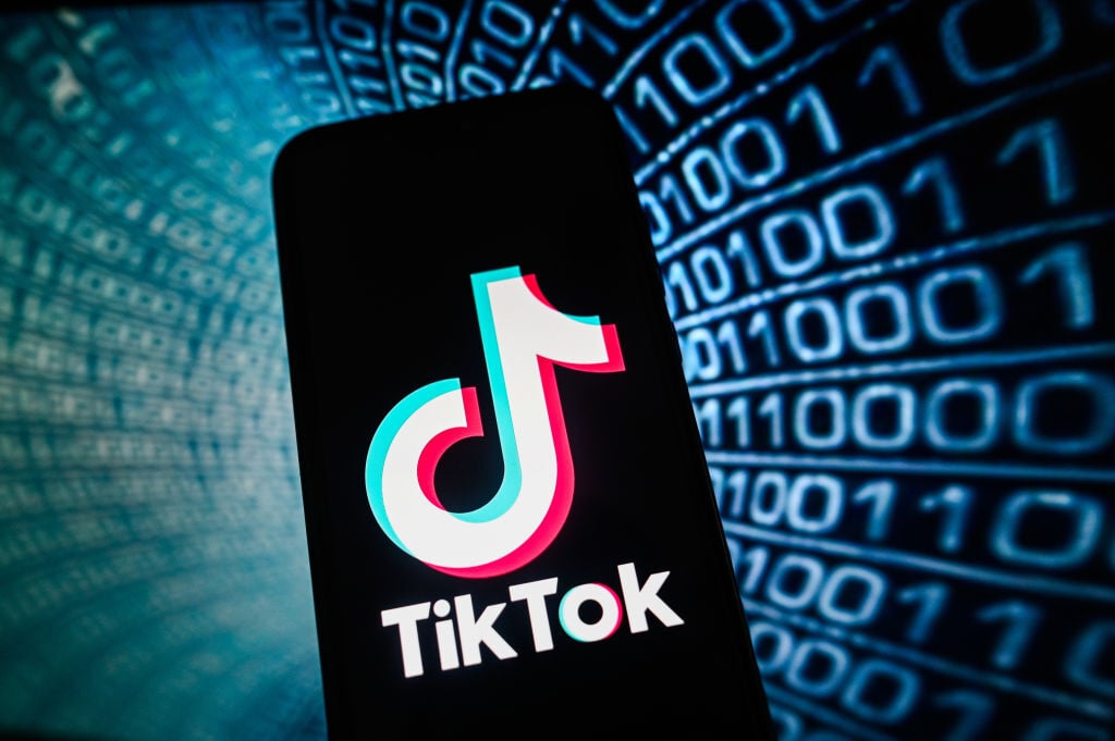 TikTok logo in front of binary code