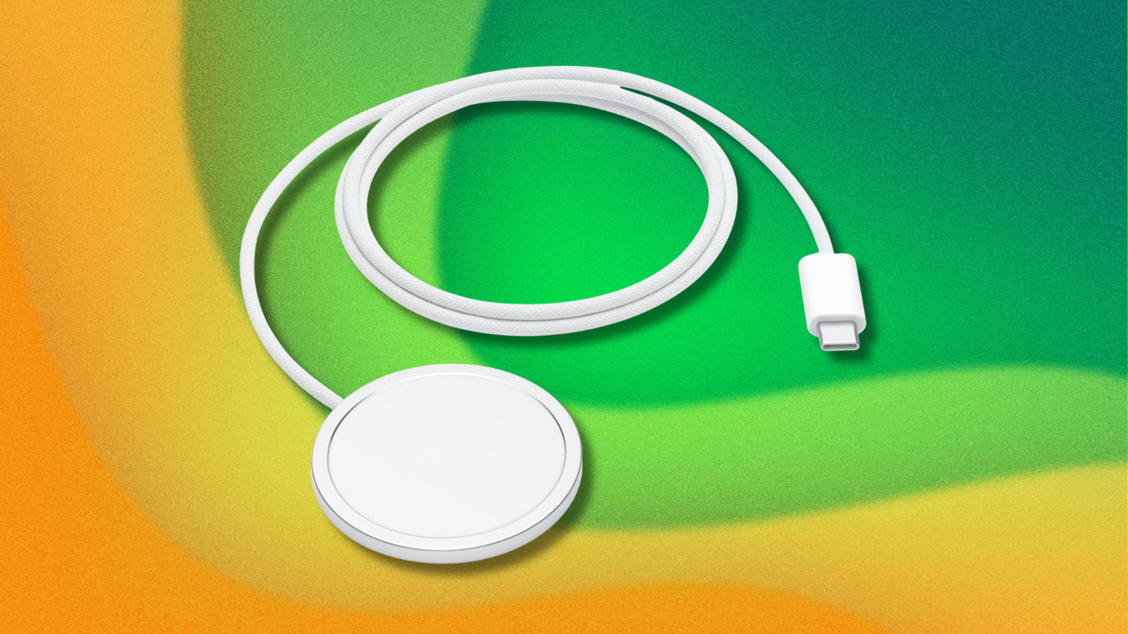 Apple MagSafe charger on green and yellow abstract background