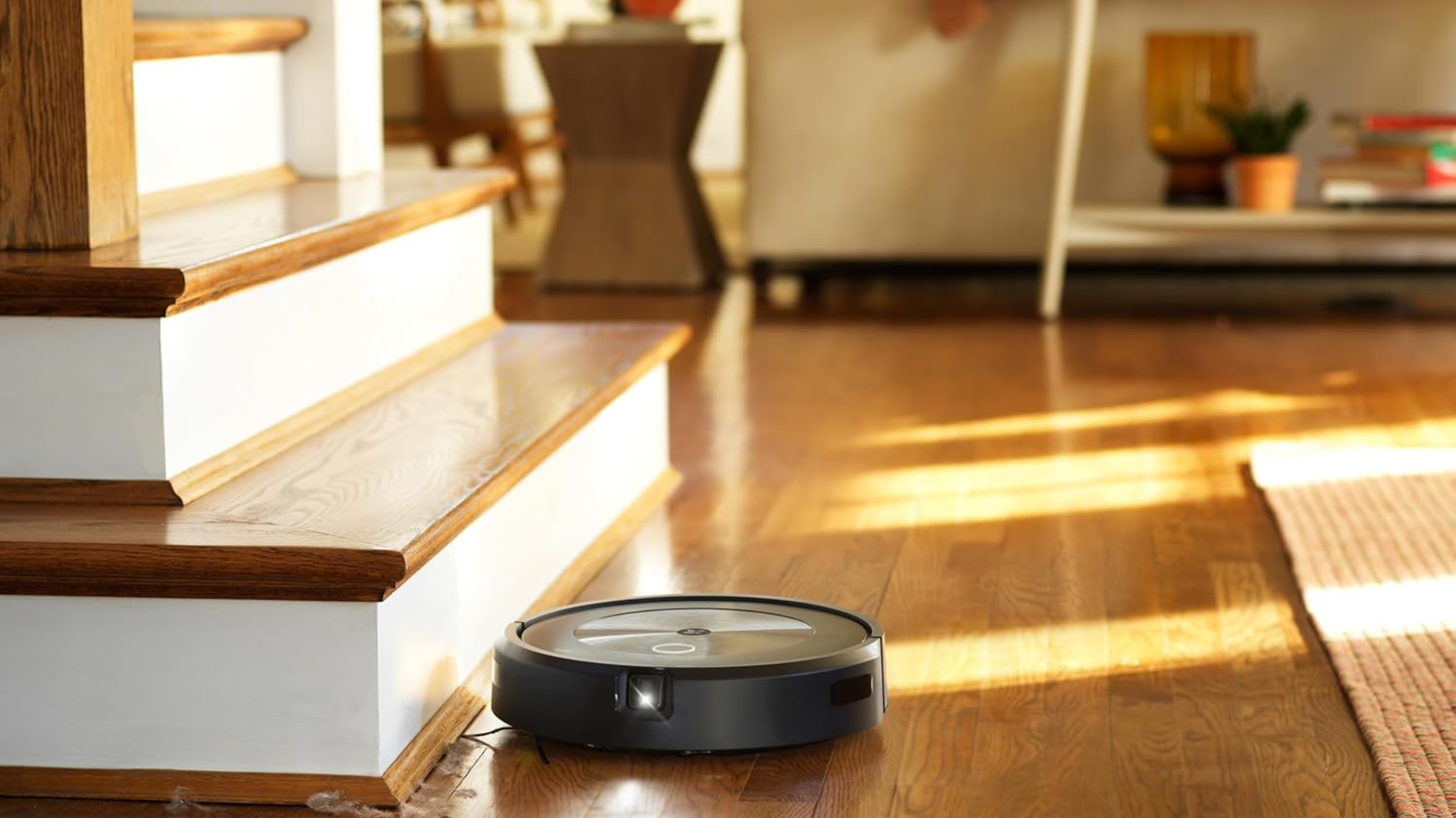 An iRobot Roomba j7+ robot vacuum sweeping a living room