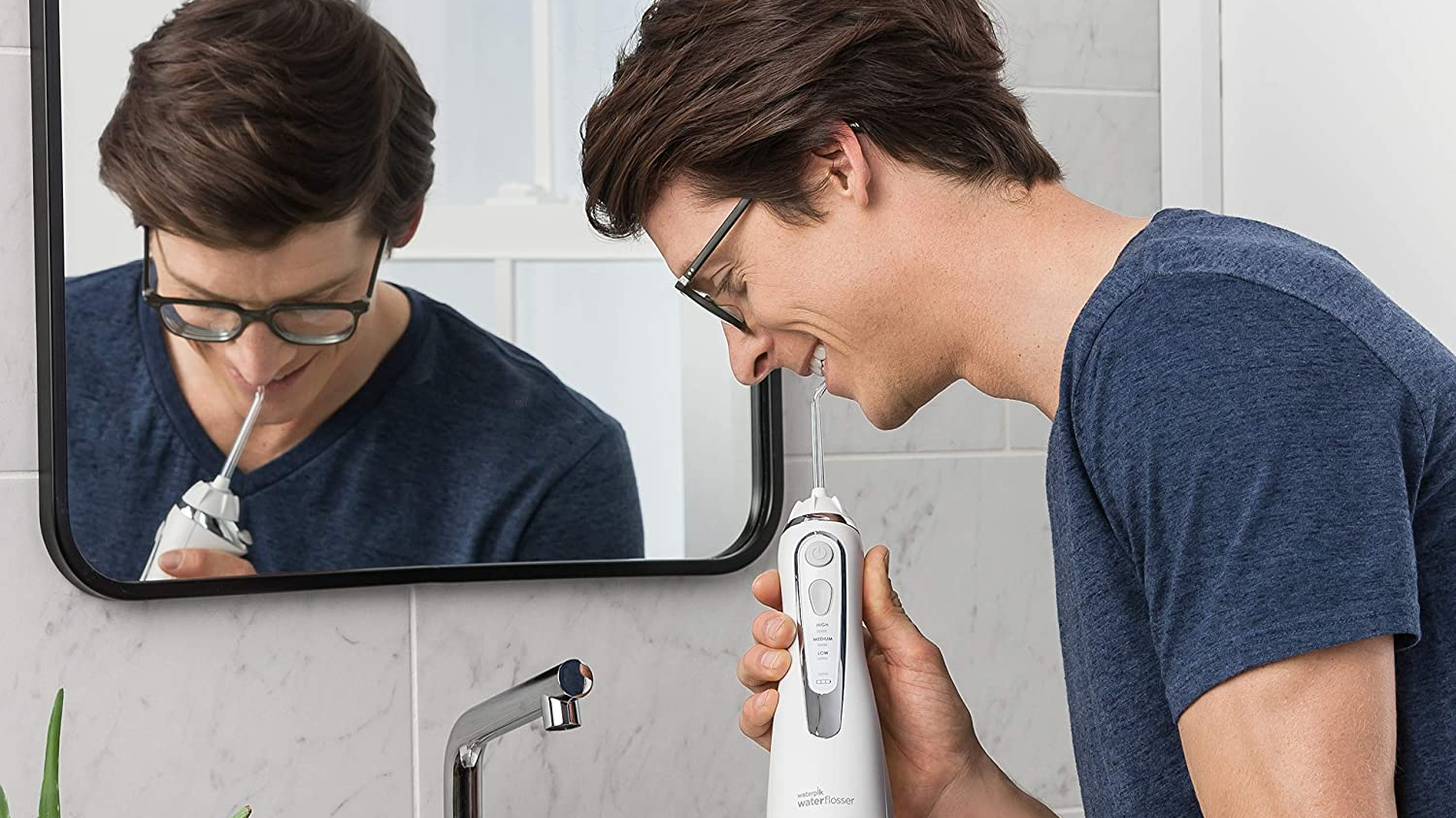 Man using a water flosser