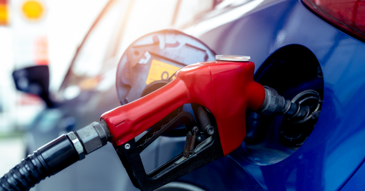 close up of a gas pump filling a blue car 