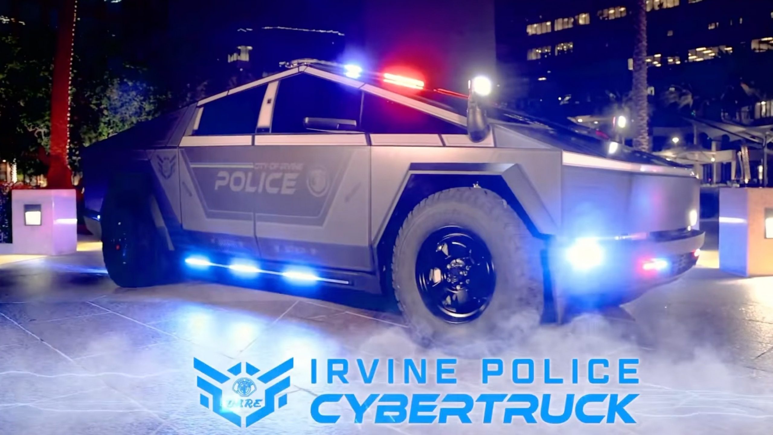 a police cybertruck lit up at night. 