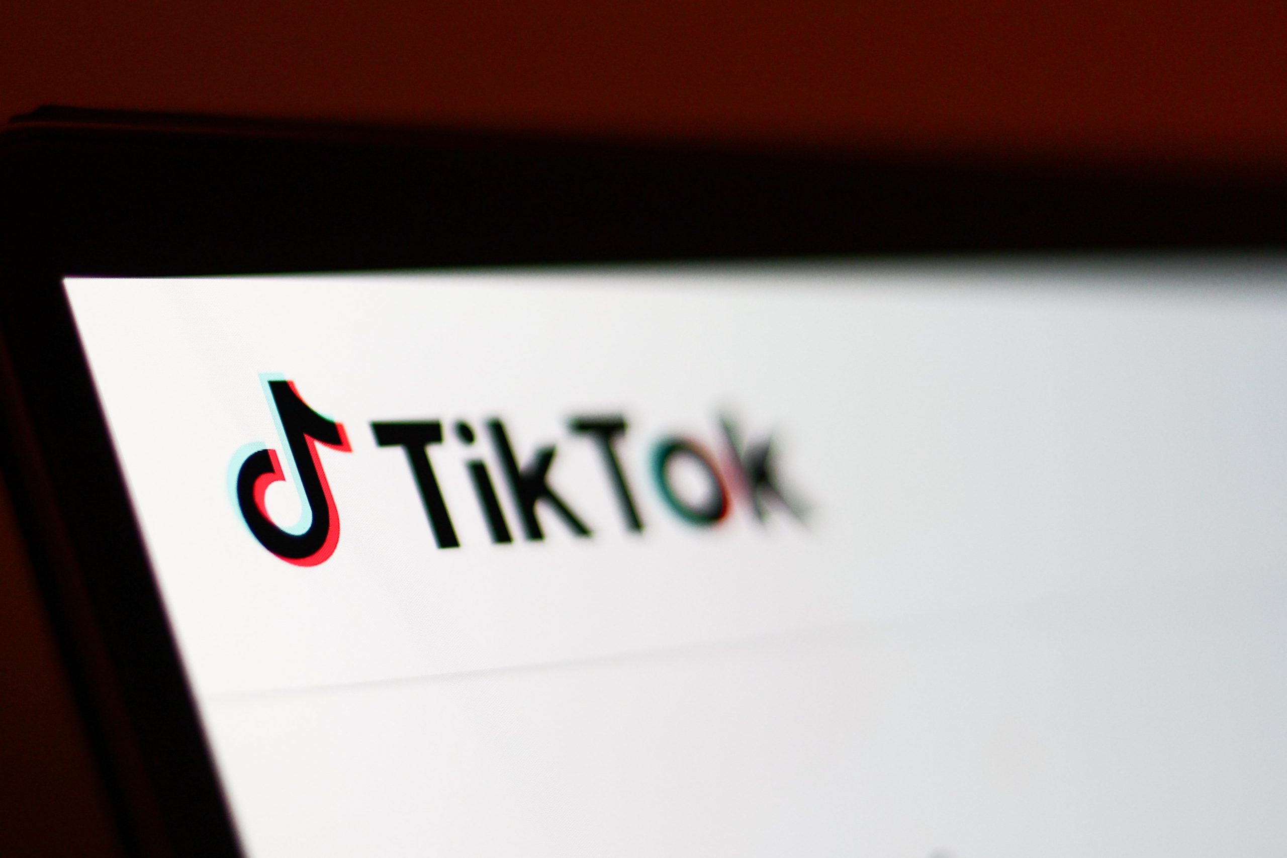 A zoomed-in photo of the TikTok homepage on a laptop screen.