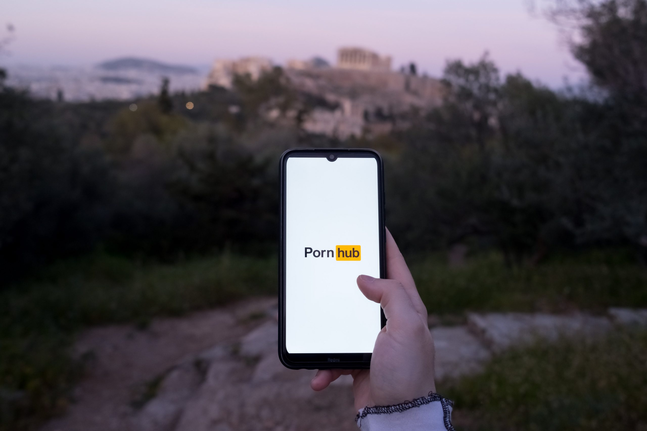 The Pornhub logo is being displayed on a smartphone screen