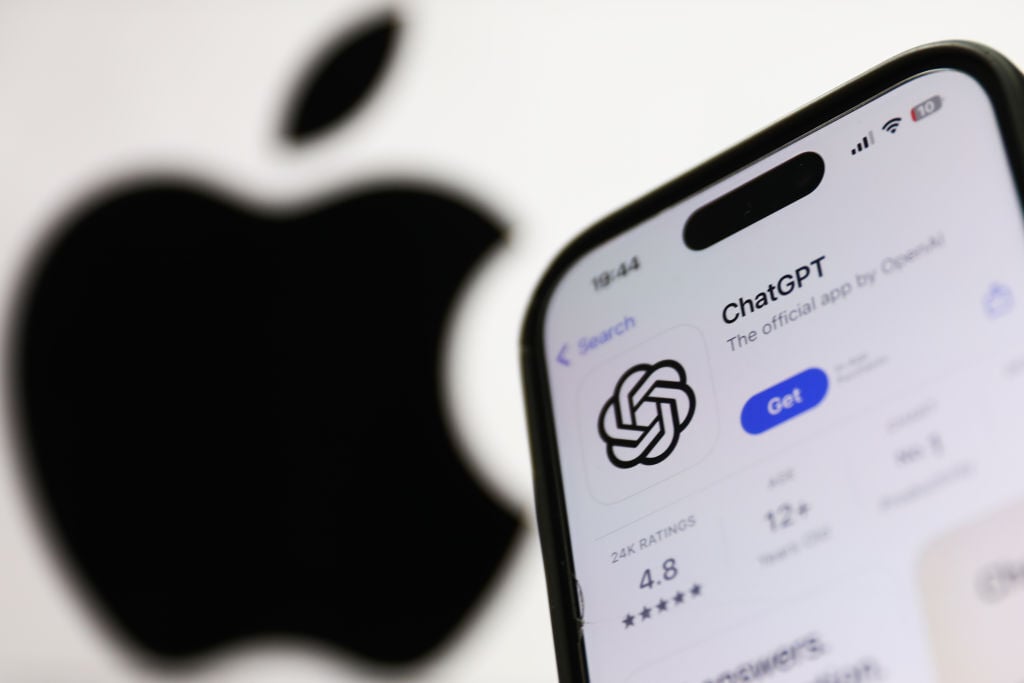 ChatGPT on AppStore displayed on a phone screen and Apple logo dislpayed on a screen in the background 