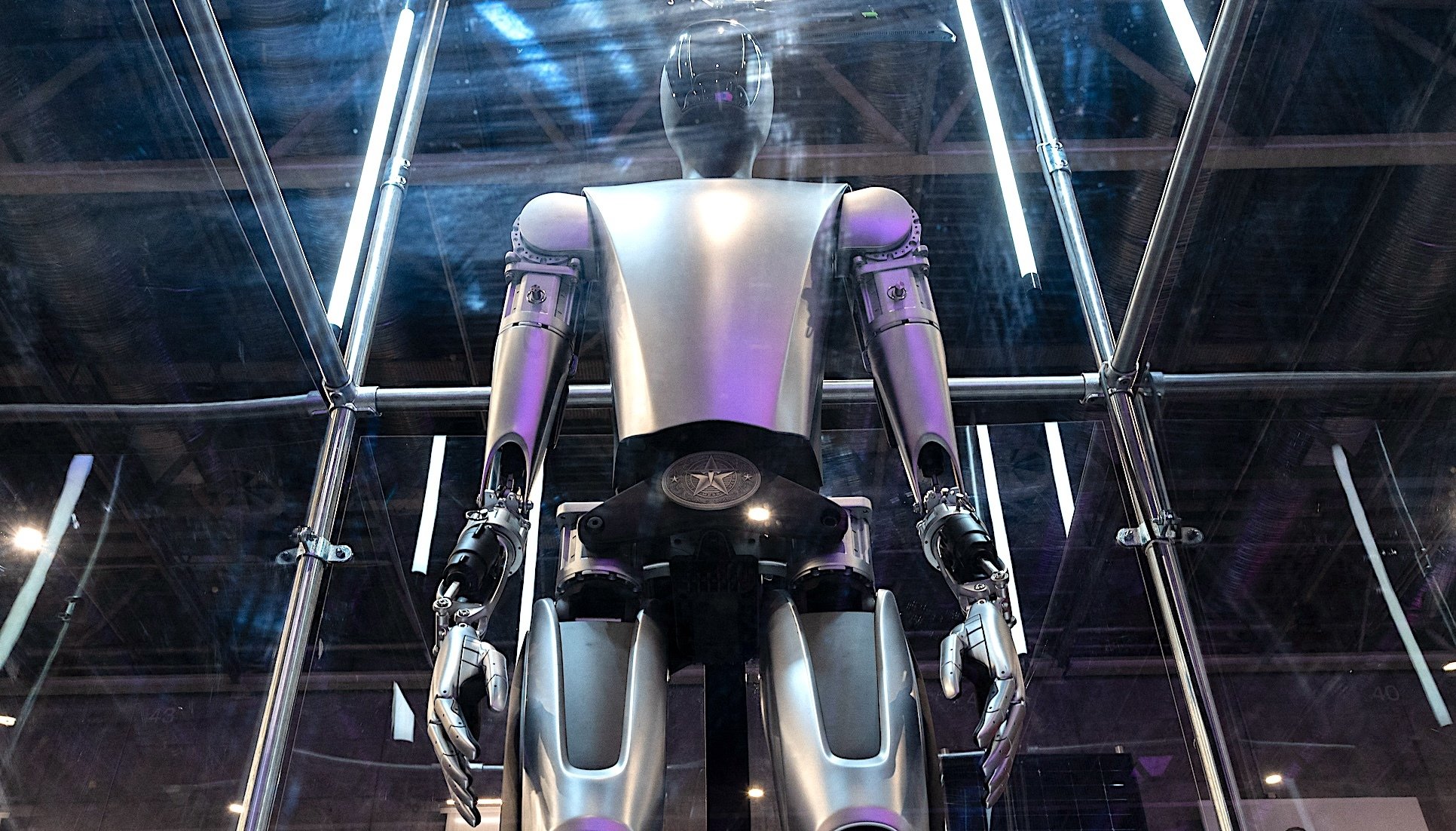 A Tesla Optimus humanoid robot viewed from below