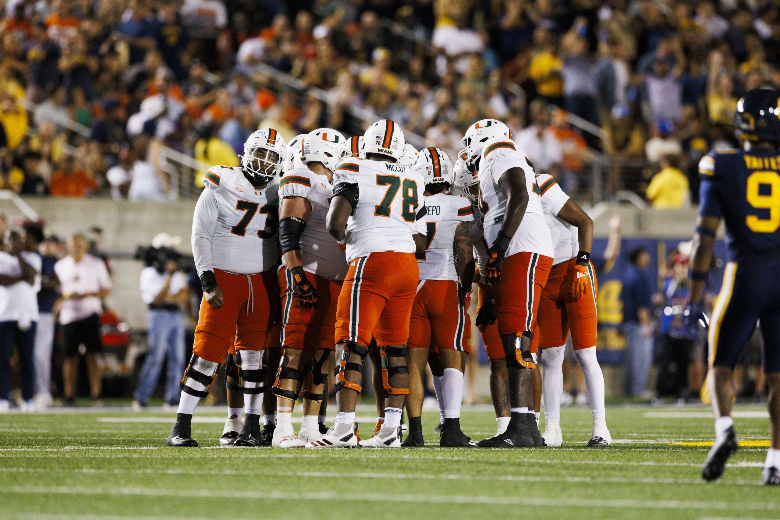 Miami Hurricanes offensive unit group huddle 