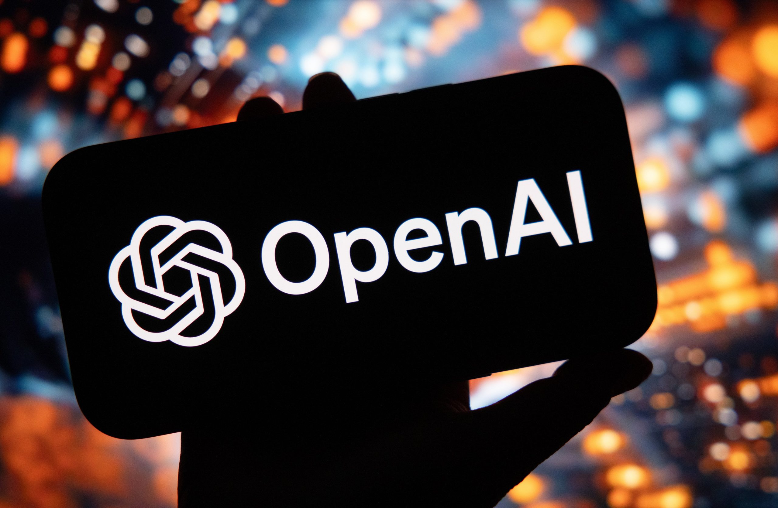 A symbol for the OpenAI virtual assistant arranged on a smartphone