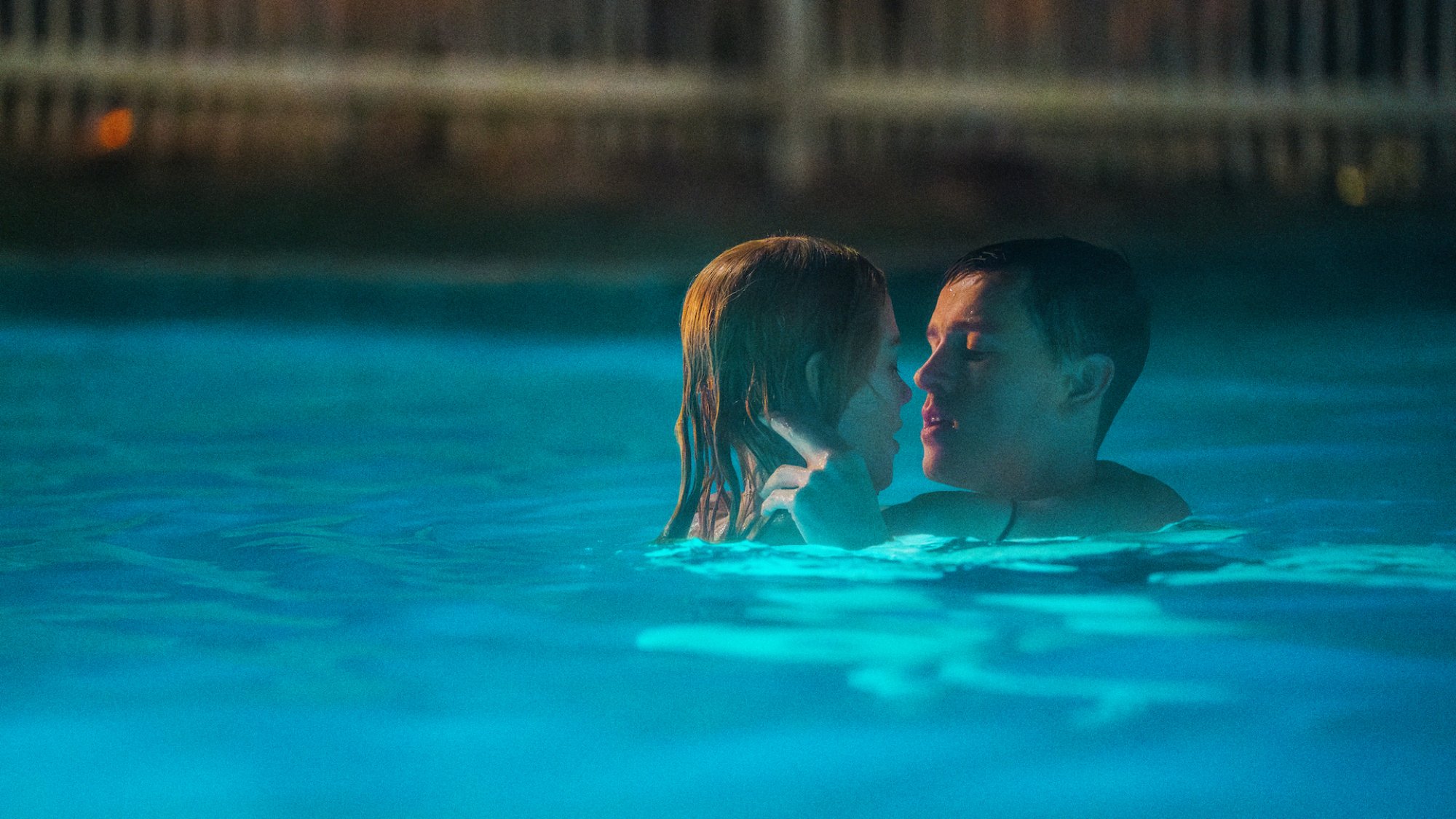 Nicole Kidman and Harris Dickinson are wrapped in each other's arms in a pool in the film "Babygirl."