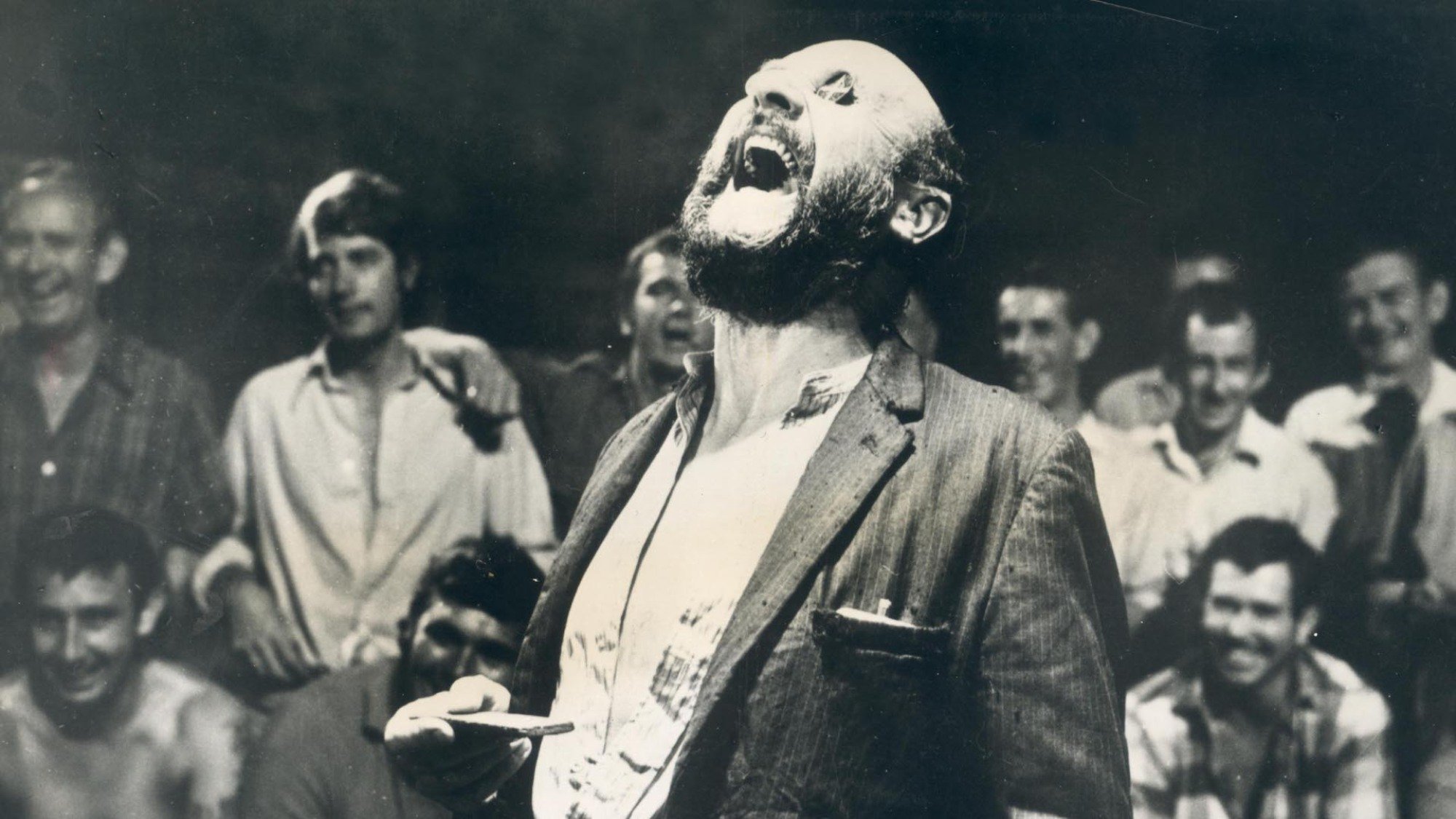 Donald Pleasence laughs with coins over his eyes in the film "Wake In Fright".