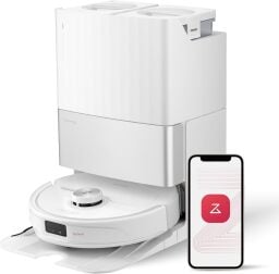 White Roborock Qrevo robot vacuum on self-empty dock and smartphone with red iRobot logo on screen