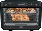 Ninja air fryer oven with fried vegetables on top rack and chicken on bottom rack