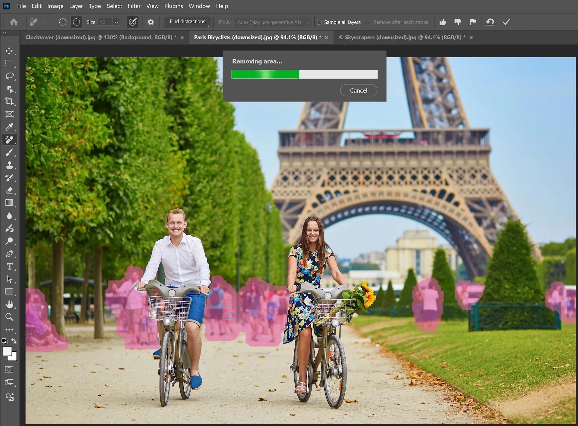 Two people ride bikes in Paris beneath the Eiffel Tower with people behind them highlighted in pink.