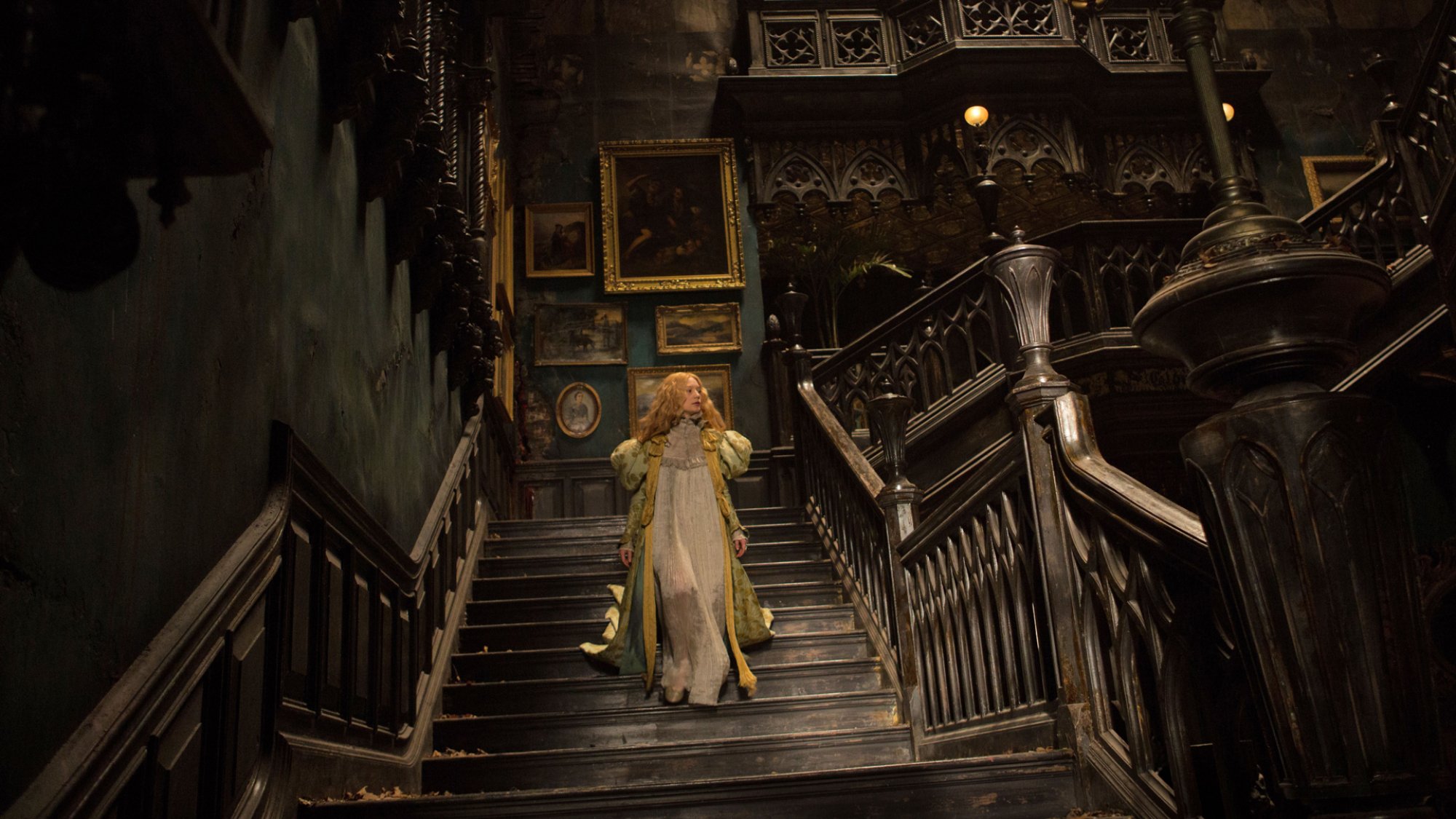 Mia Wasikowska descends a Victorian Gothic staircase in the film "Crimson Peak."