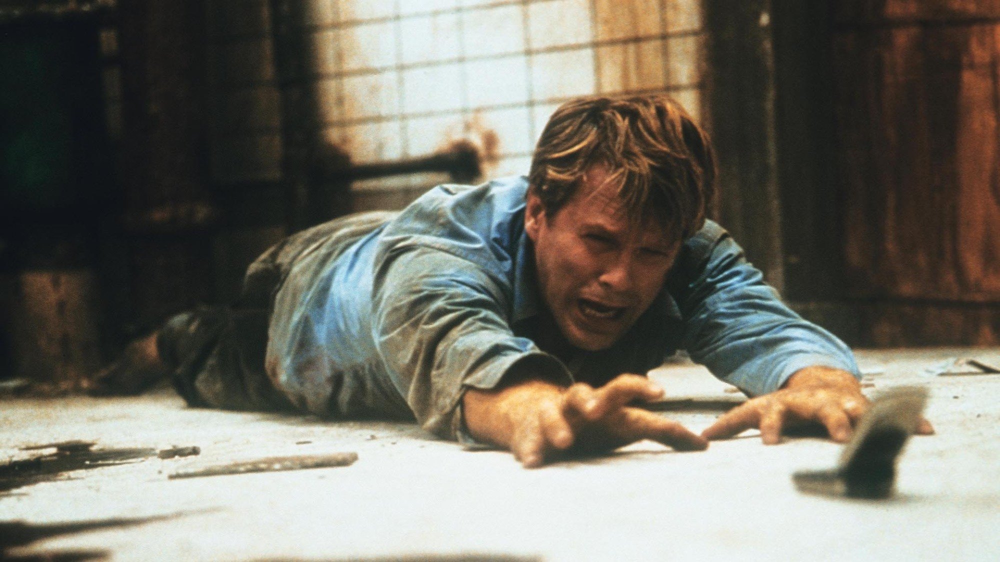 Cary Elwes looks in despair in a dilapidated bathroom in the film "Saw."