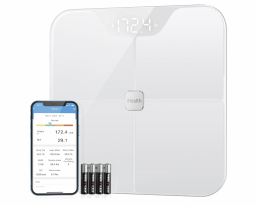 white smart scale beside phone