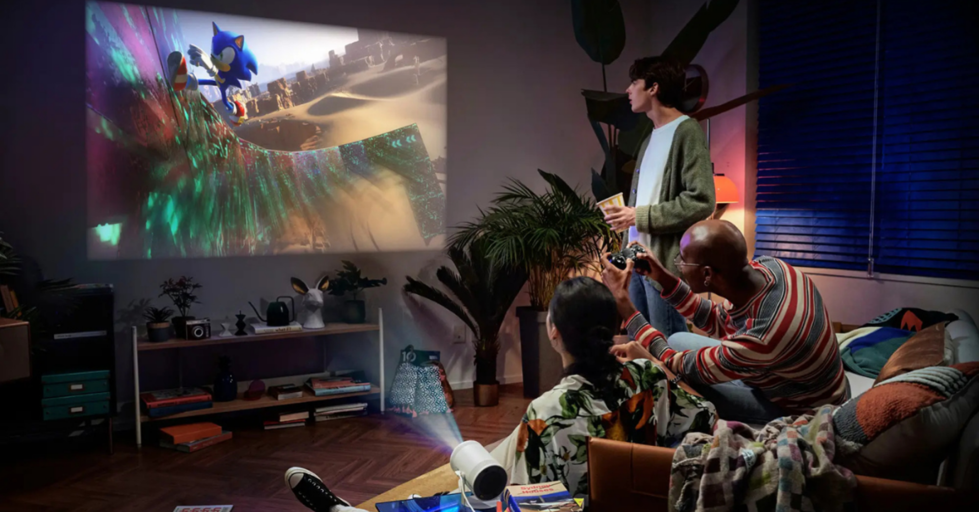 a group of people playing sonic the hedgehog via the samsung freestyle projector 