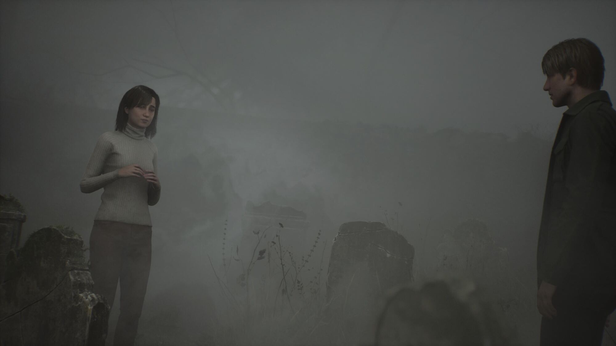 A man and a woman stand facing each other in a foggy cemetery. The woman, wearing a light grey turtleneck sweater, appears solemn as she holds her hands together. The man, dressed in dark clothing, gazes at her from a short distance, with gravestones barely visible through the thick mist.