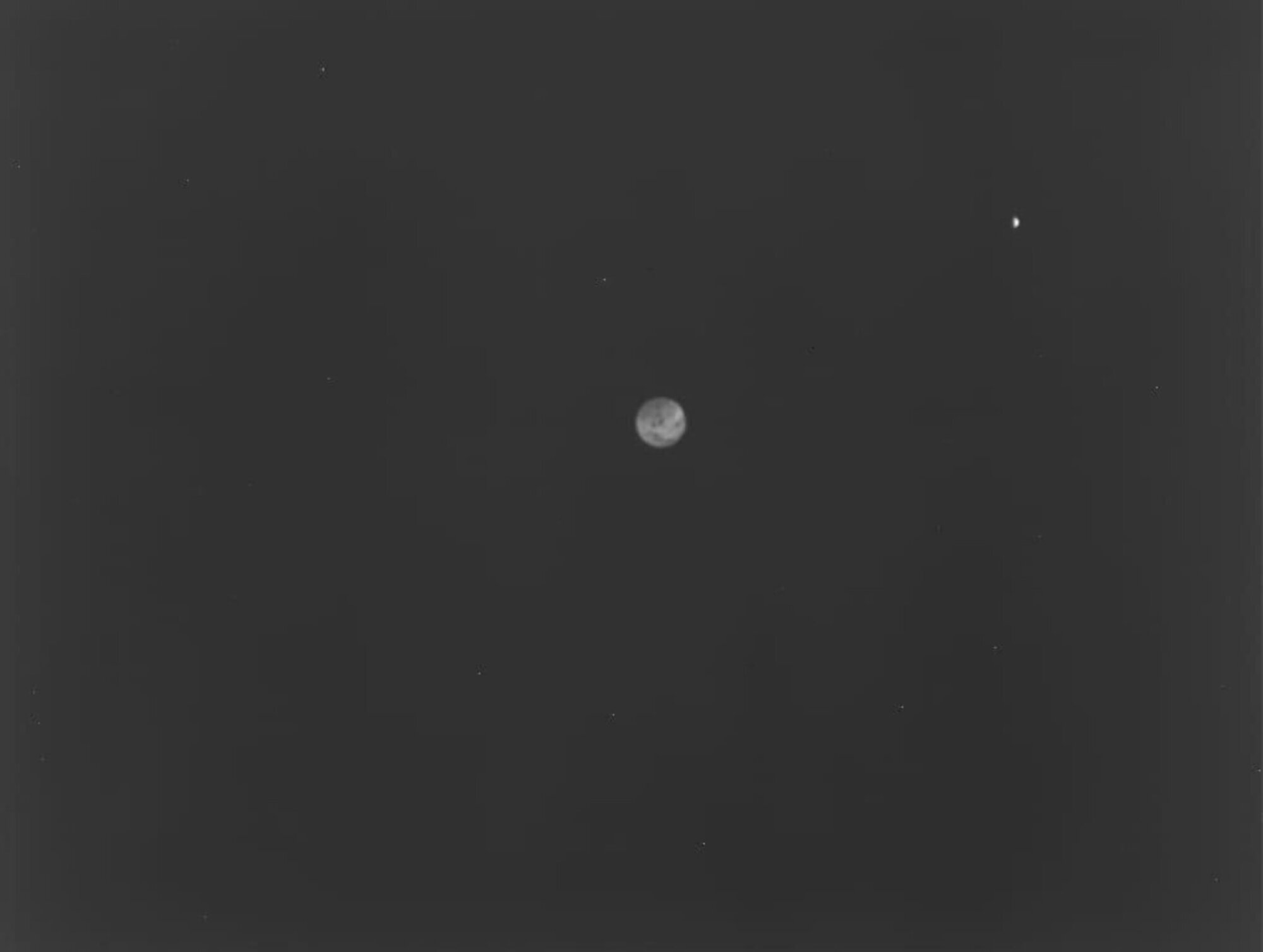 Earth (center) and the moon (upper right) as viewed by Hera's Thermal Infrared Imager.