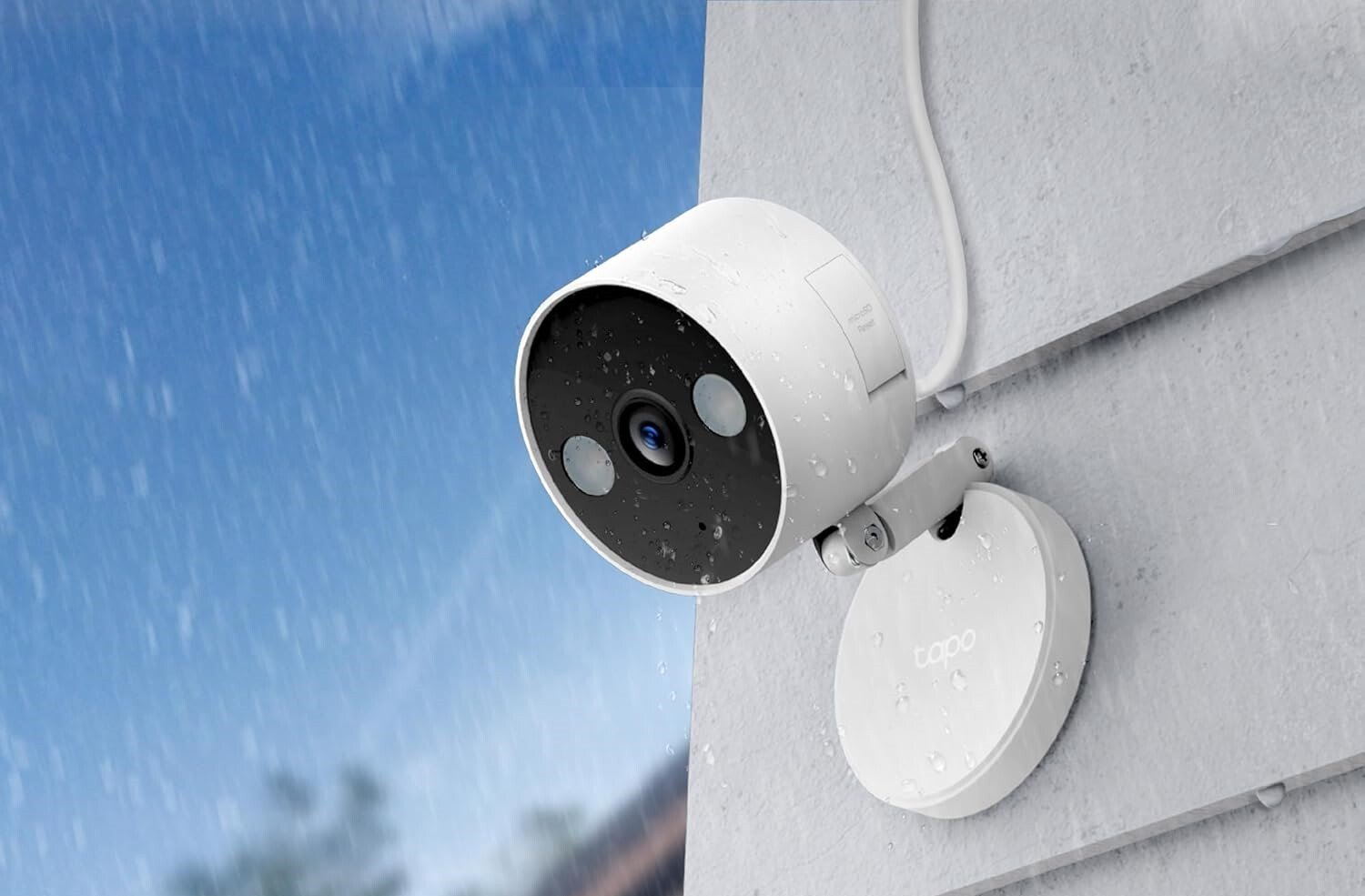 a home security camera on a home's exterior in rainy weather