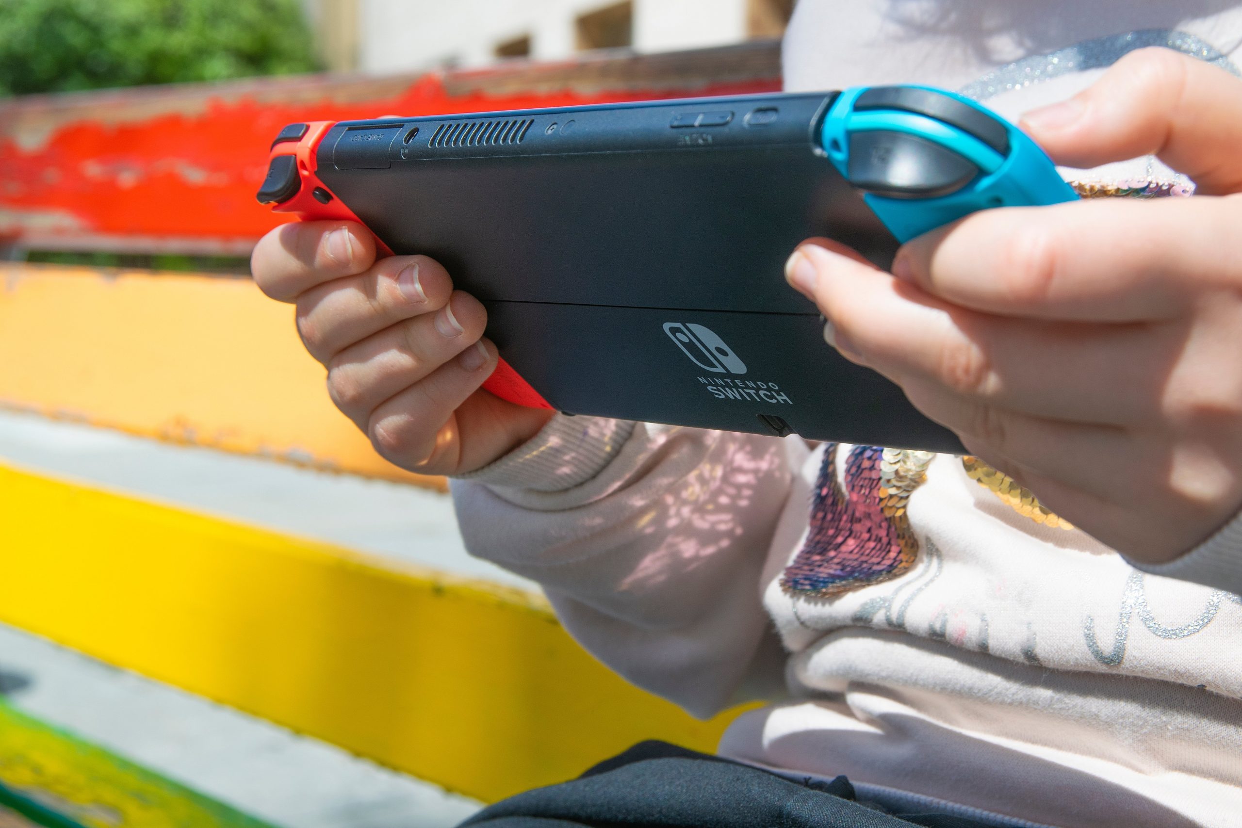 Person holding Nintendo Switch handheld console