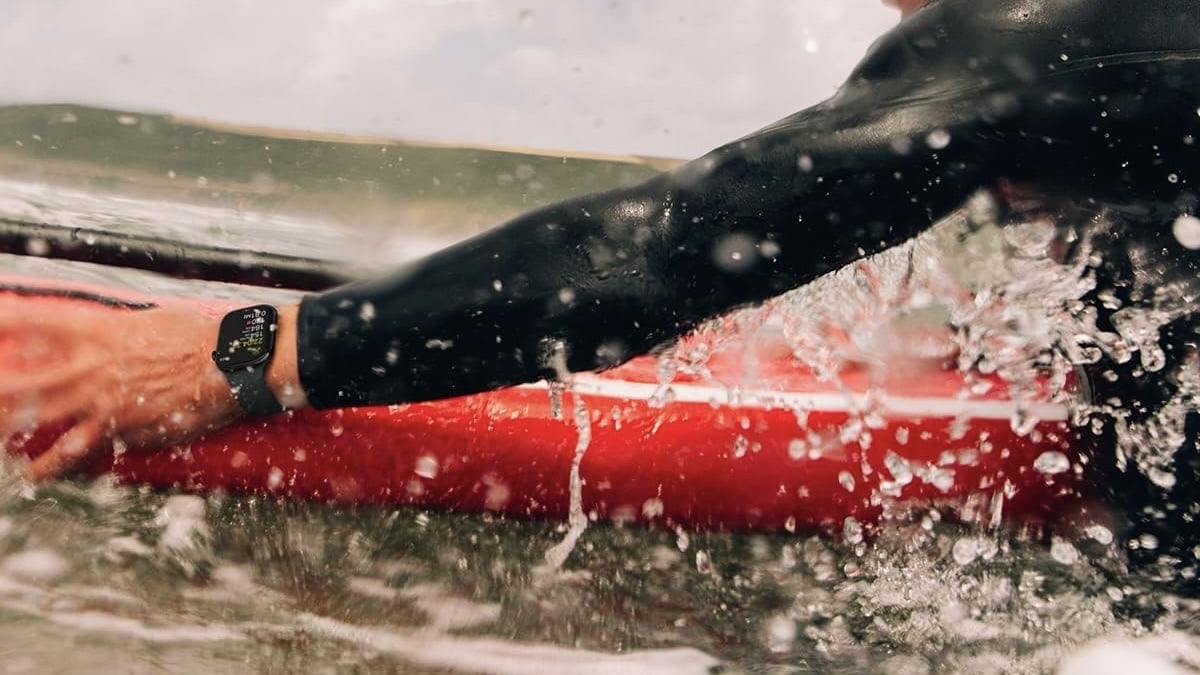 person wearing apple watch series 10 on a surfboard