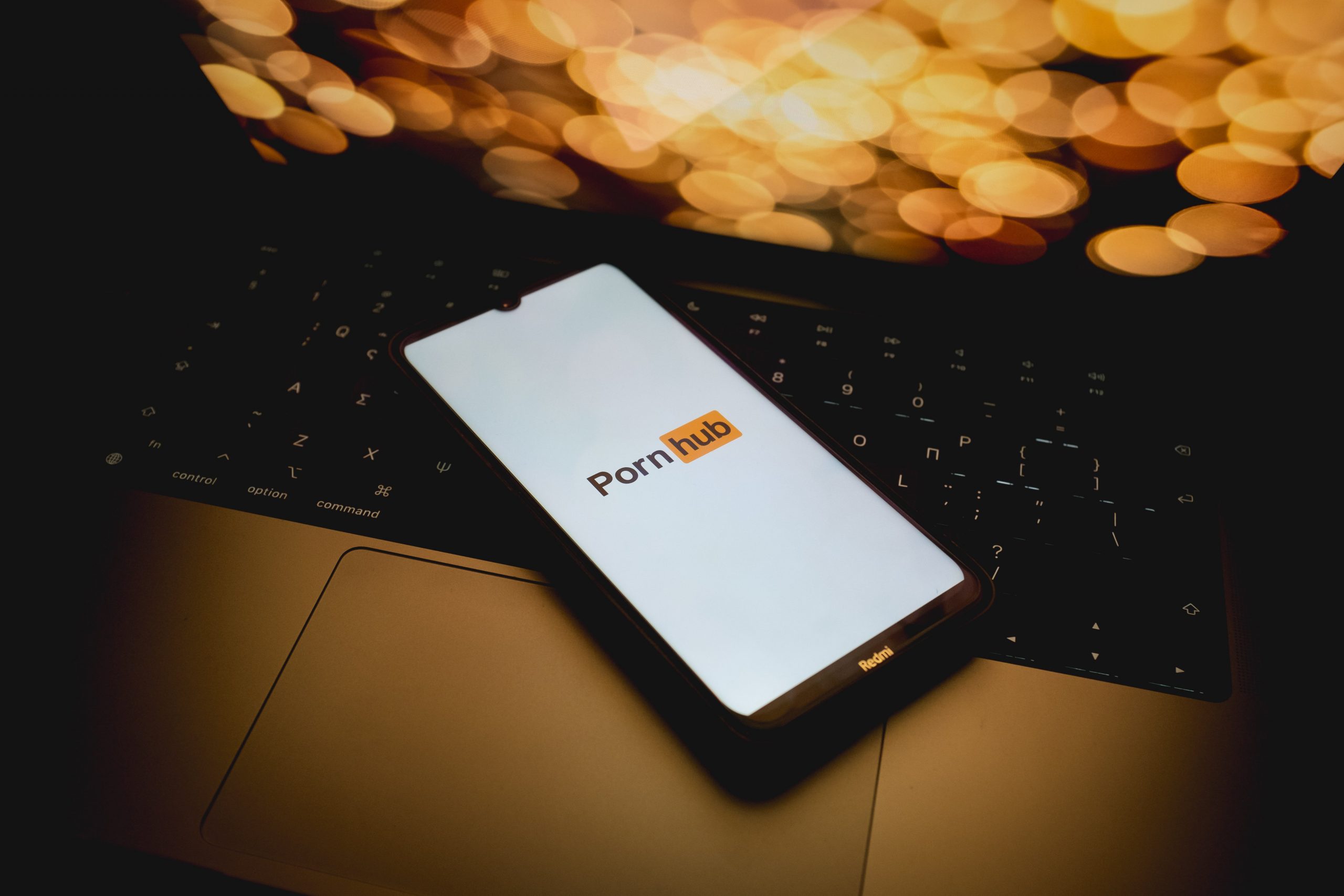 The Pornhub logo is being displayed on a smartphone screen