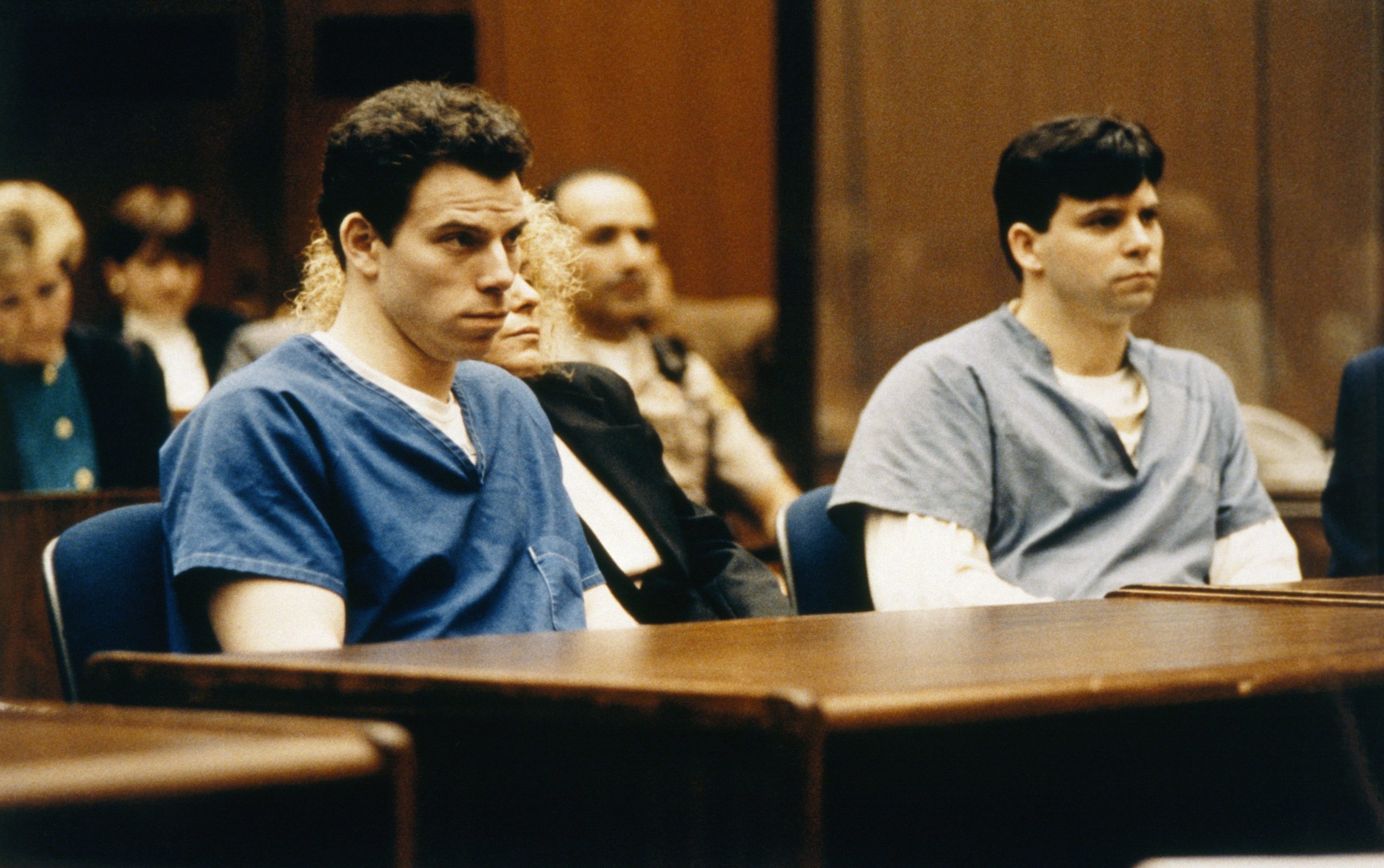 Erik Menendez, left, and his brother Lyle, wearing jail outfits during their court trial