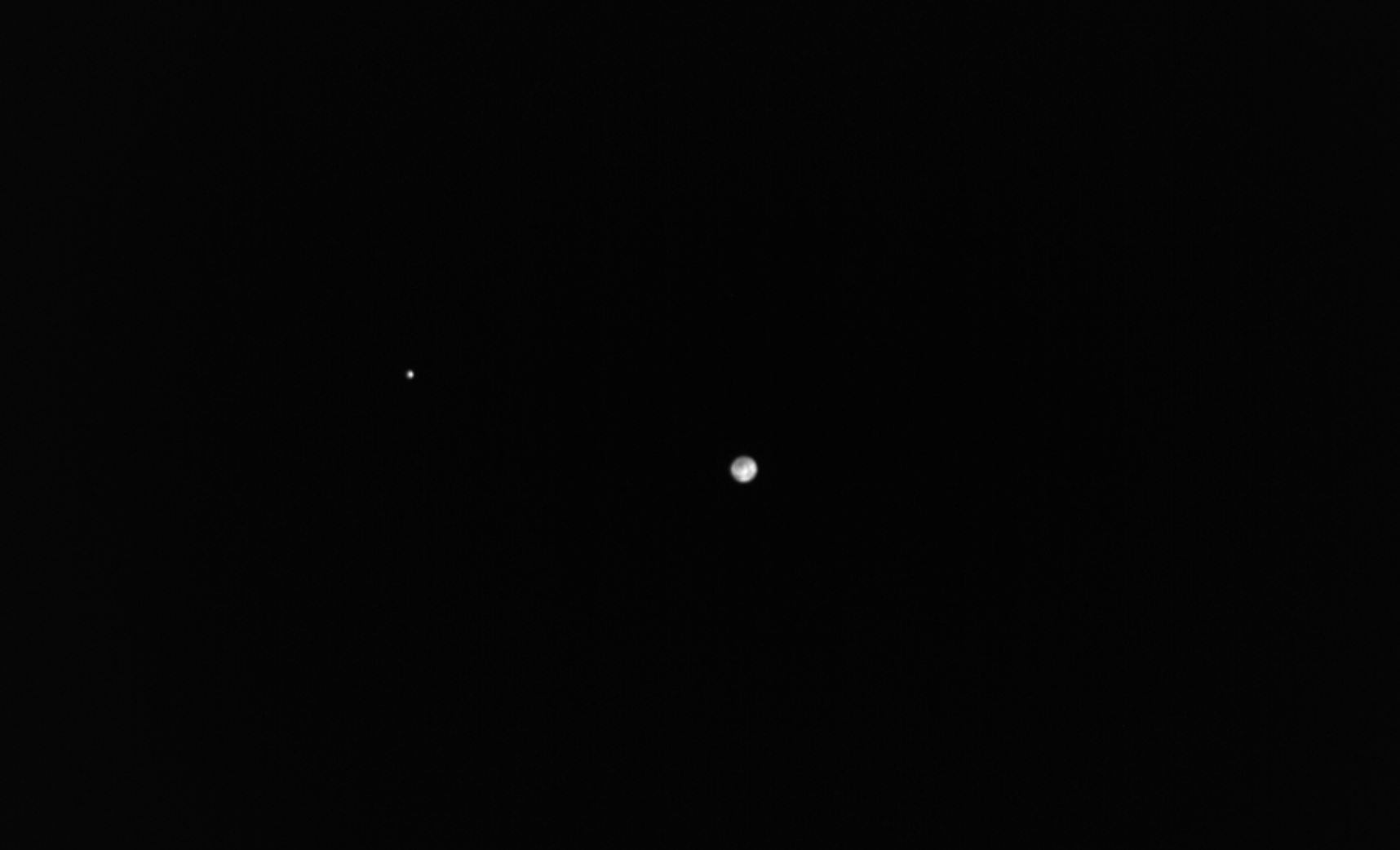 Earth and the moon as viewed by the European Space Agency's Hera mission. 