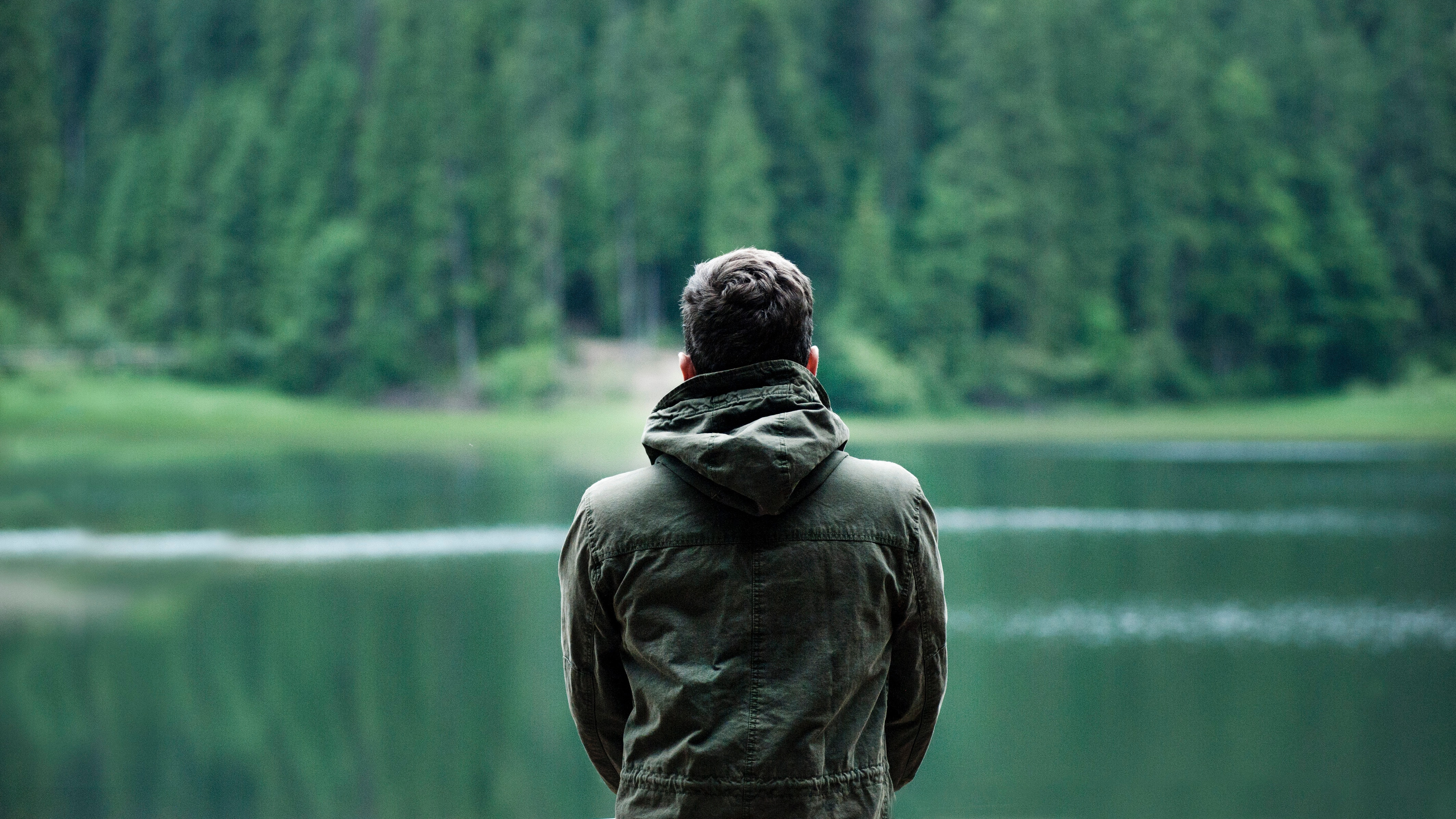 A man stood at a lake