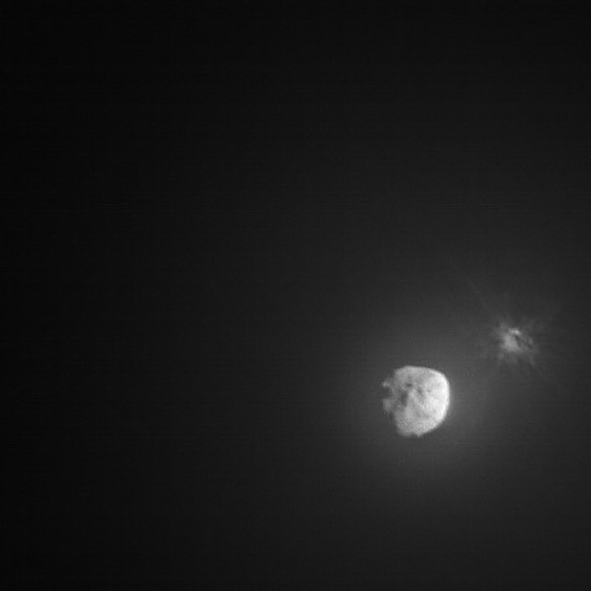 The asteroid Dimorphos, on right, after impact by NASA's DART spacecraft in 2022. Dimorphos orbits the asteroid Didymos as part of a binary asteroid system.