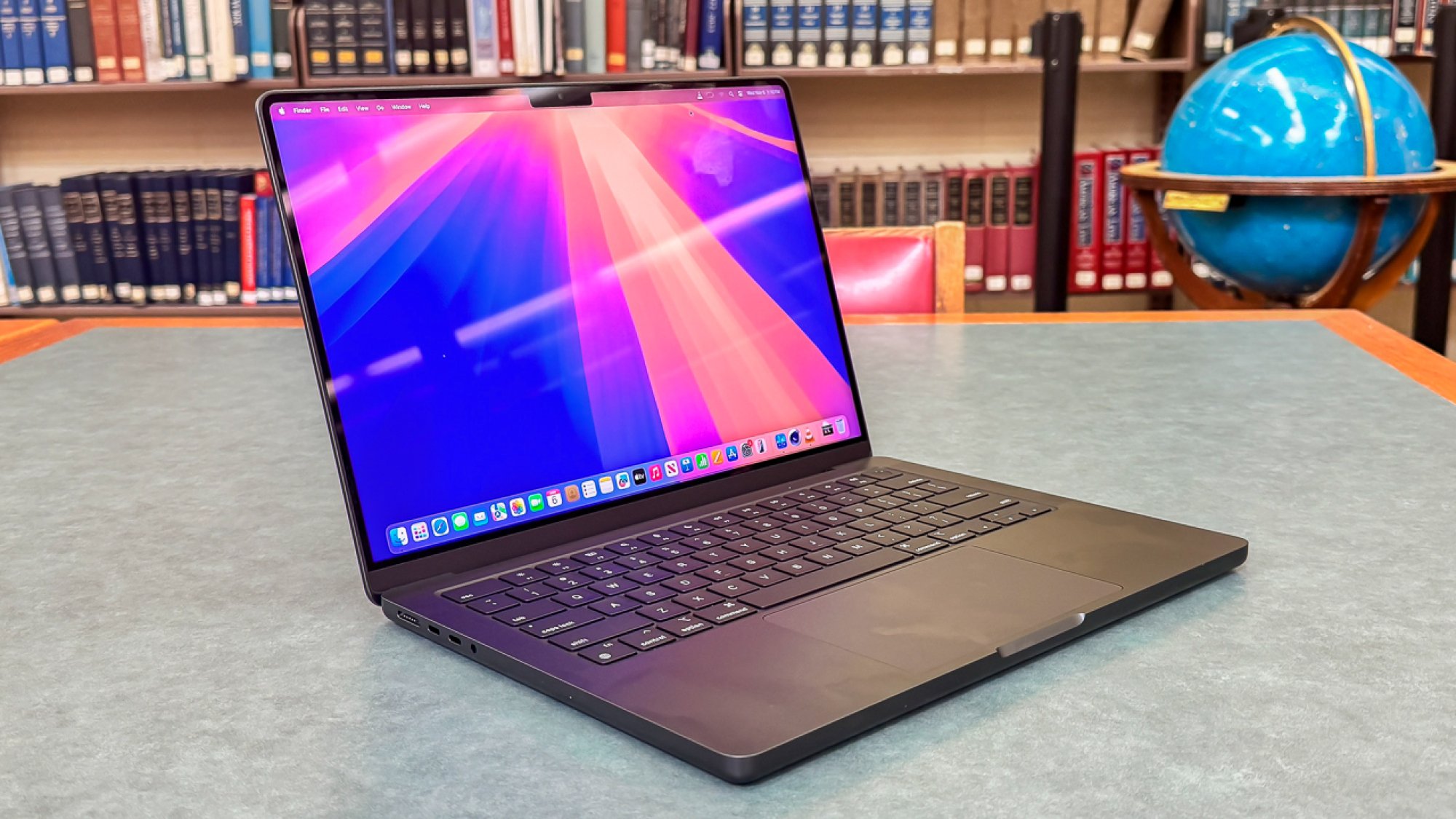 Apple MacBook Pro (14-inch, M4) in a library backdrop