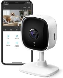 a tapo tp-link security camera in front of a smartphone displaying the associated app