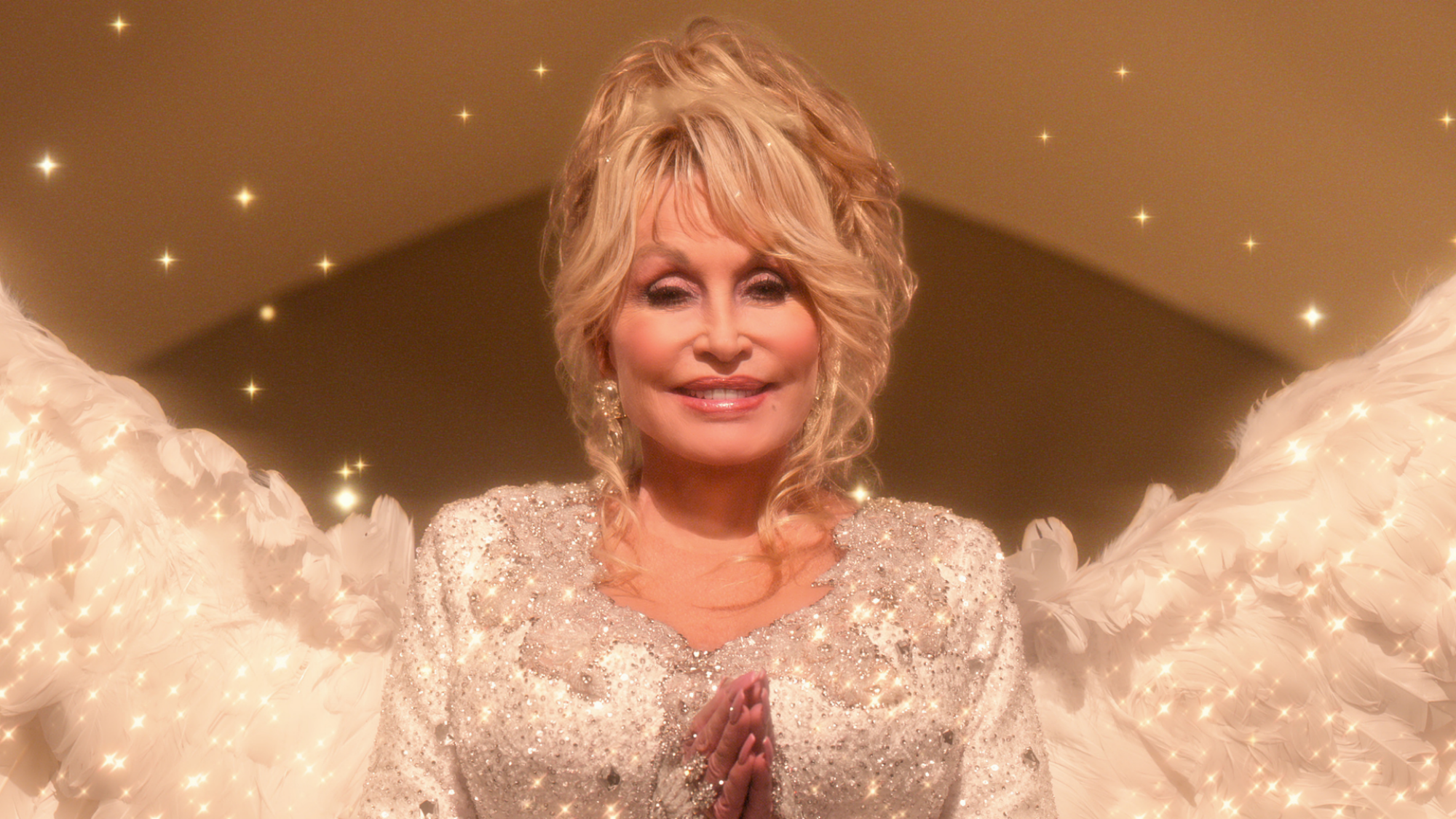 Dolly Parton wears white and angel wings in "Dolly Parton's Christmas on the Square."